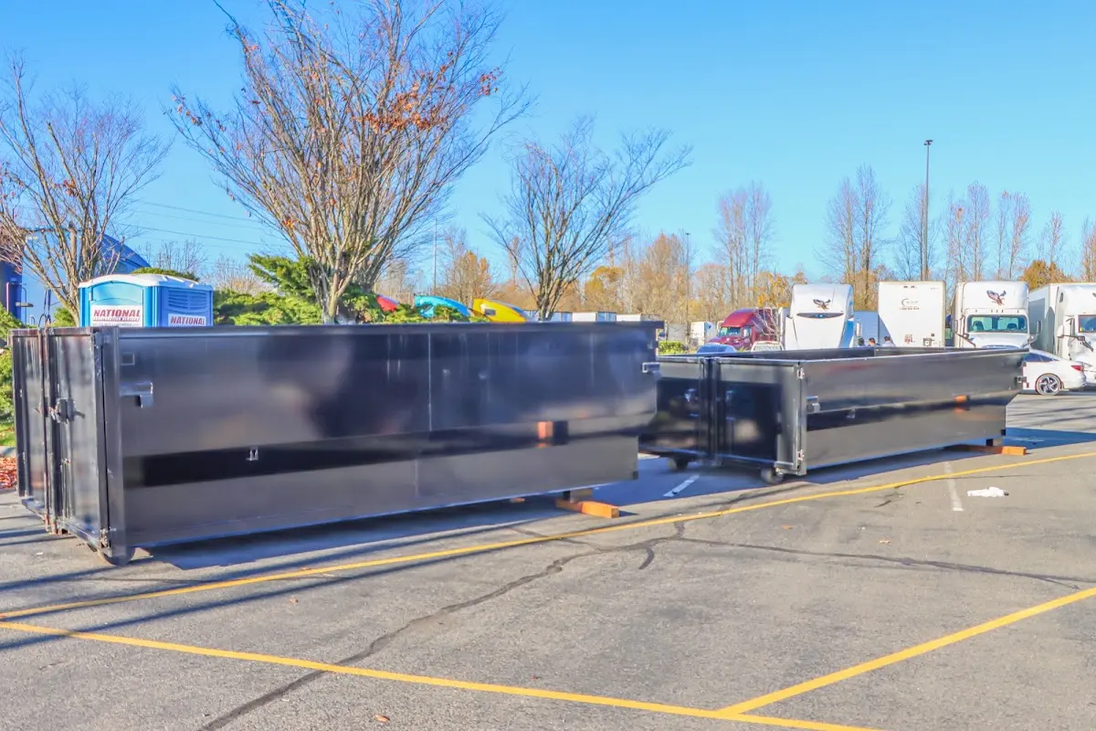 Professional dumpster rental service with roll-off container on residential driveway in Bellefontaine Neighbors